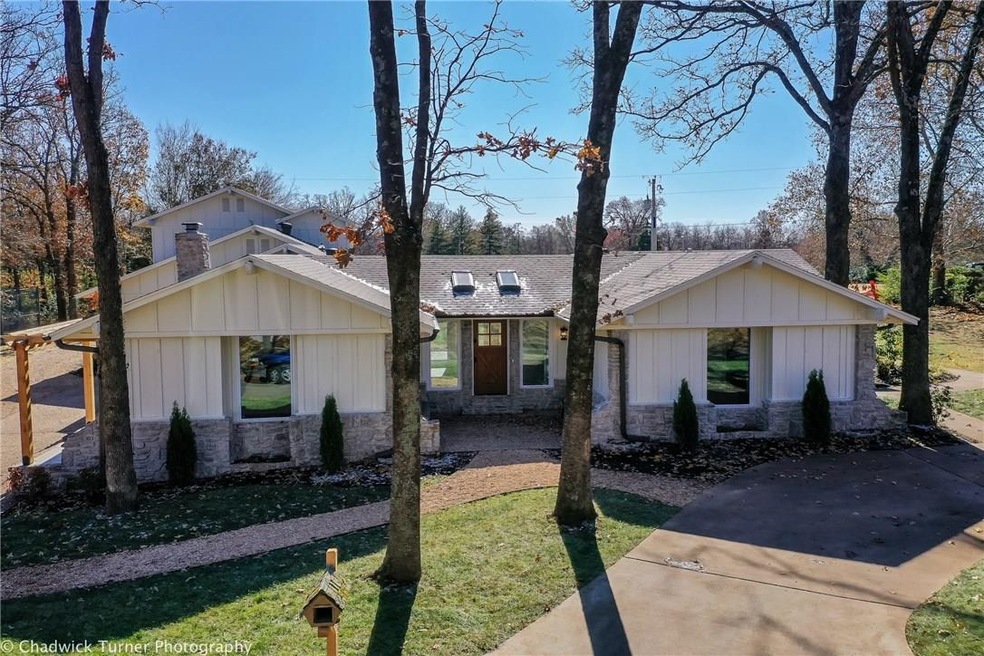 Welcoming entry with mature trees.
