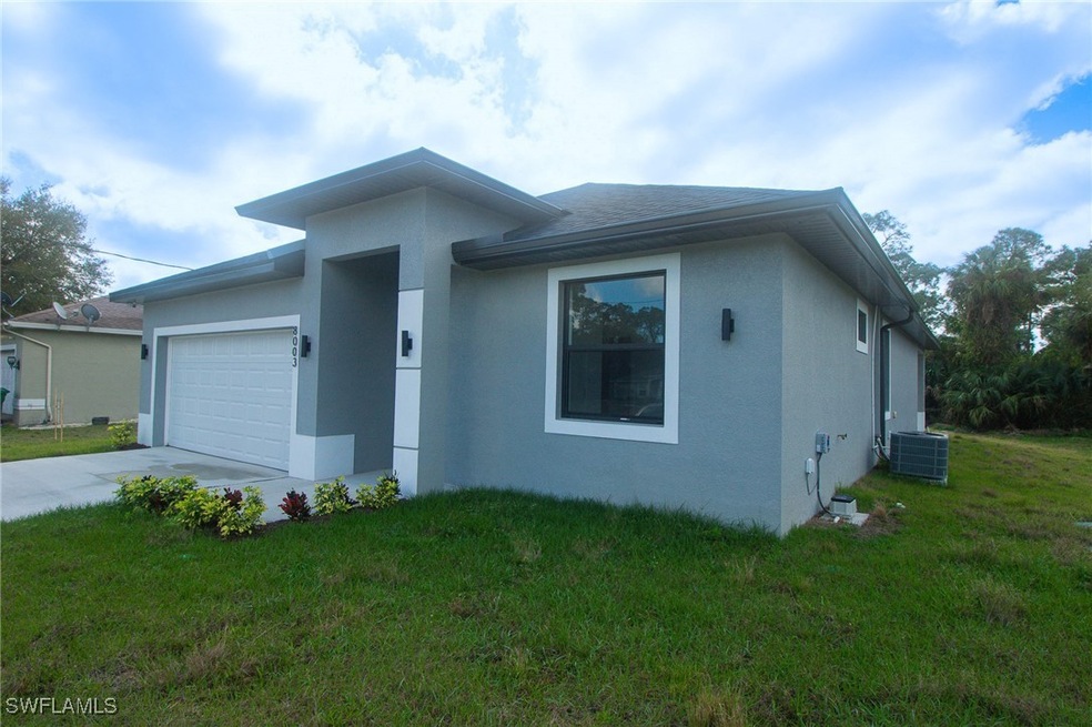 View of front of property with a garage, a front y