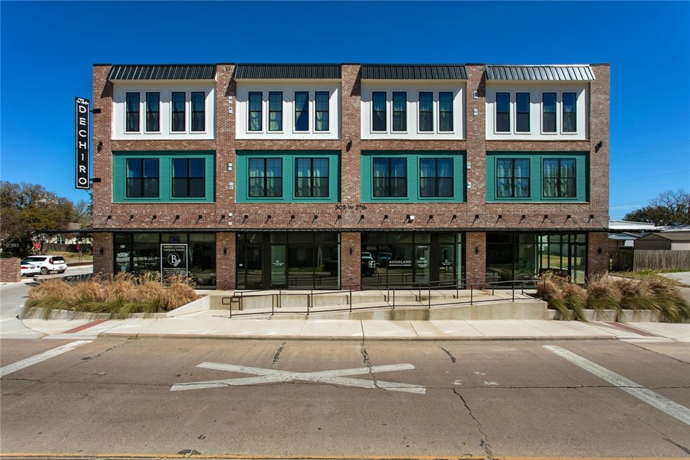 View of property featuring uncovered parking