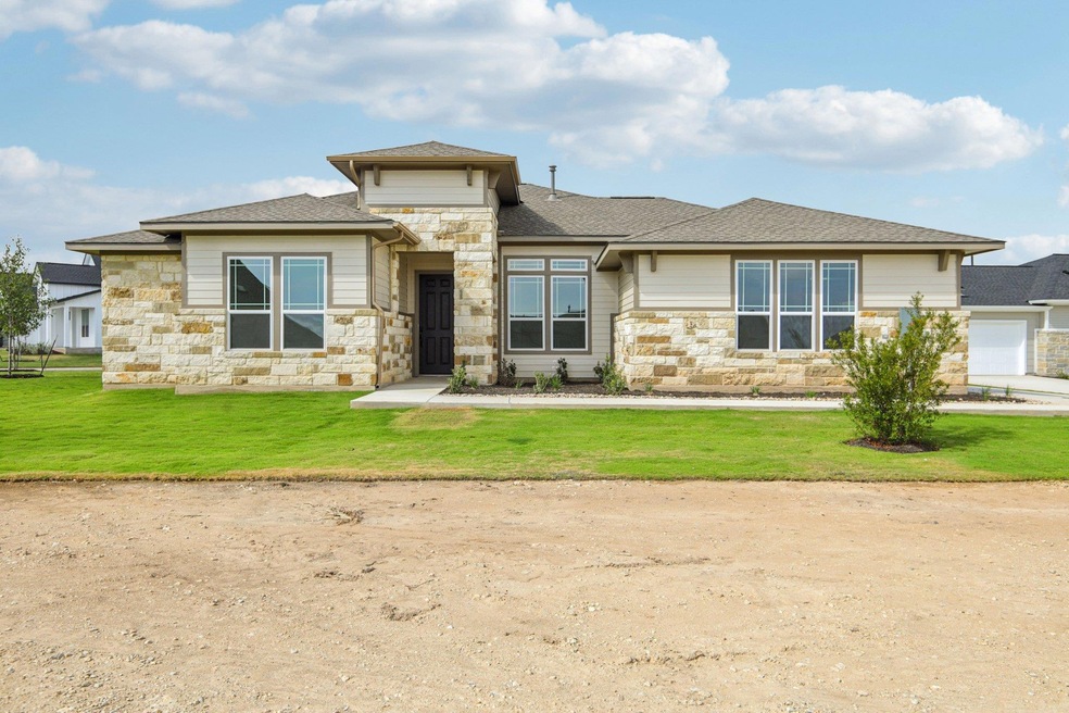 Prairie-style home with stone siding, a shingled roof, and a front yard