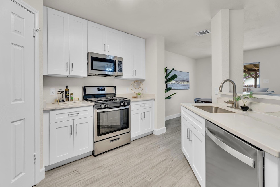 Kitchen featuring stainless steel appliances, whi