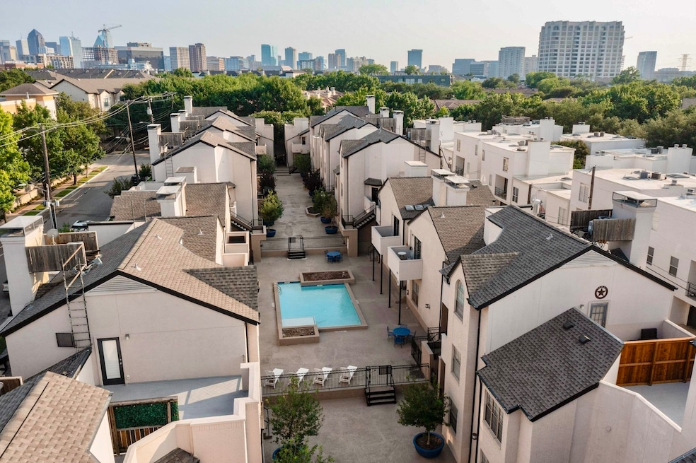 Drone / aerial view of a pool area and city skyline
