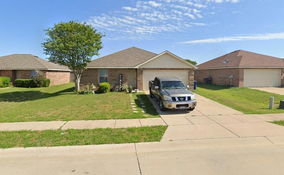 Ranch-style house featuring a front yard and a garage