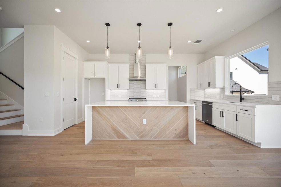 Kitchen with visible vents, wall chimney range ho
