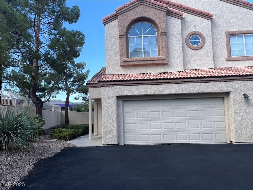 Garage with asphalt driveway