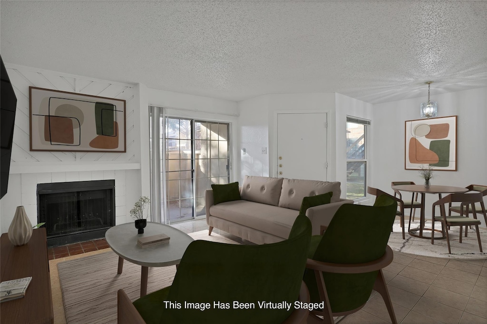 Living room featuring tile patterned flooring, a f