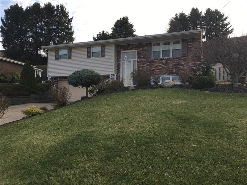 Beautifully manicured lawn welcomes you to this ho