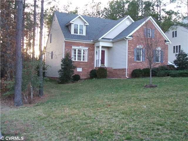 Exterior Front - Brick & Vinyl cape on a wooded, q