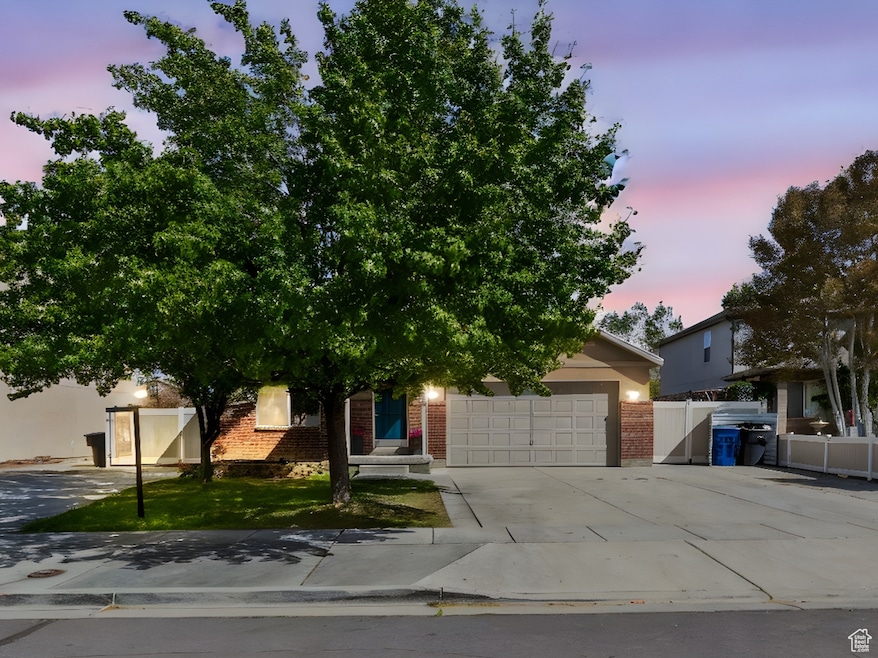 RV PLUS EXTRA PARKING, MOTHER IN LAW APT ENTRANCE, FENCED YARD, MATURE TREES, View of property hidden behind natural elements featuring concrete driveway, a garage, and brick siding