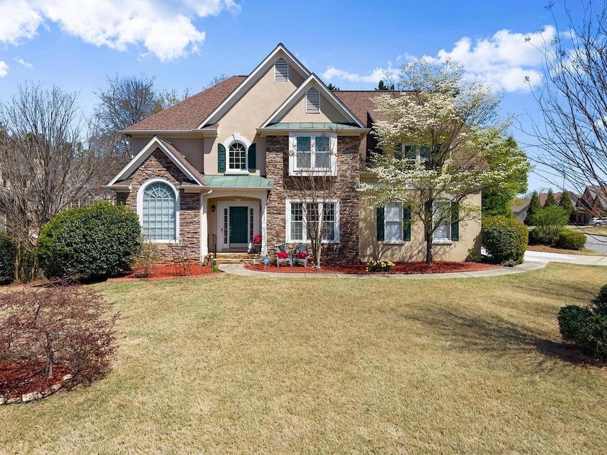 Traditional-style house with stone siding, a front