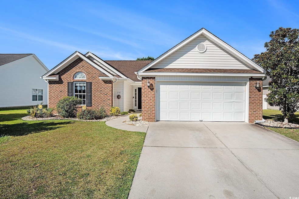 Single story home with brick siding, concrete driveway, and a front yard