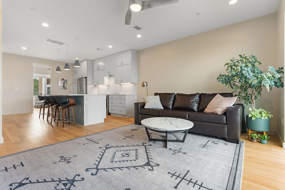 Living room with light wood-style flooring, visib