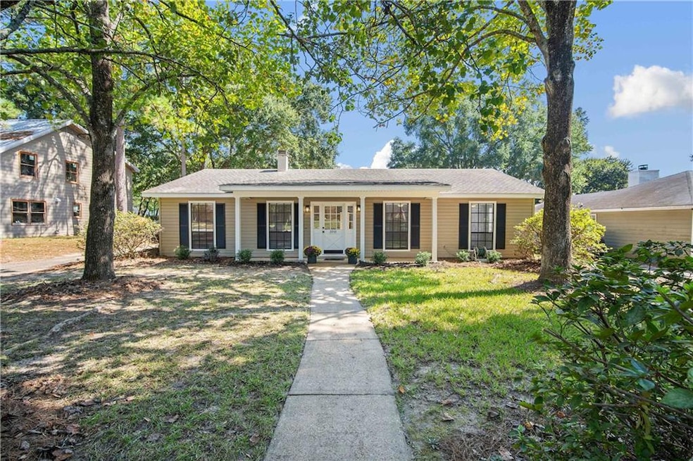 Single story home featuring a front lawn
