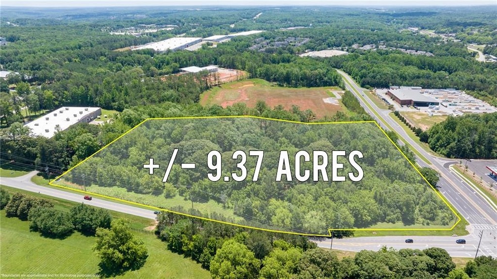 Aerial view of property's location featuring property parcel outlined and a heavily wooded area