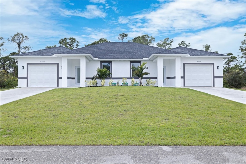 View of front facade with a front yard, a garage,