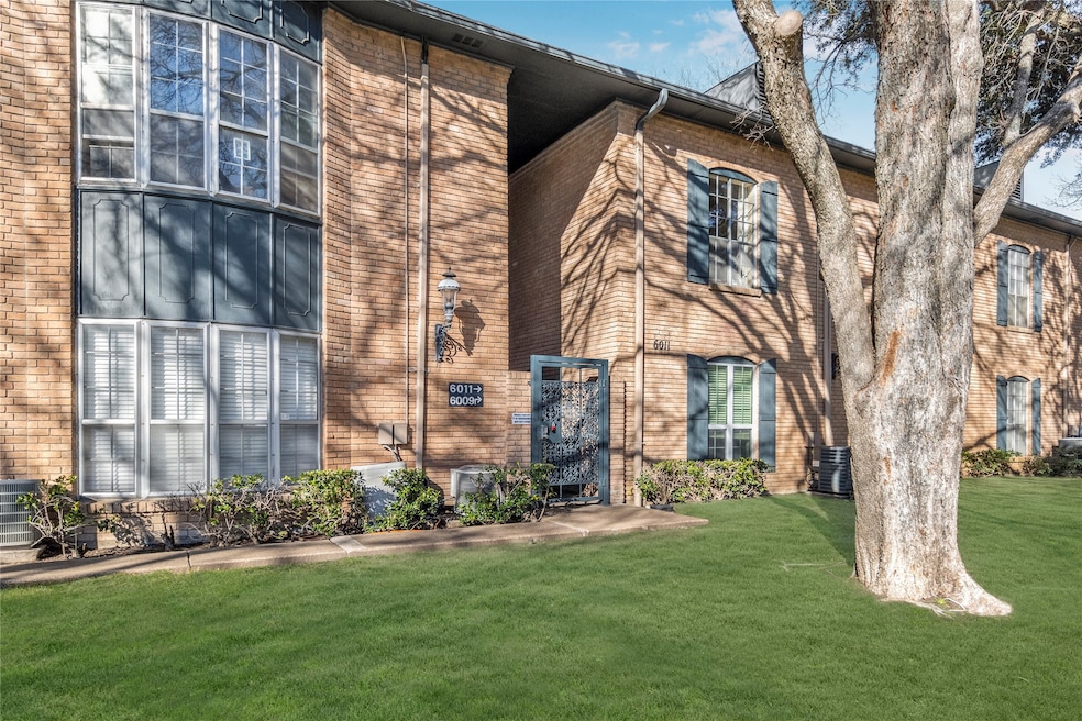 View of front of property with a front yard and brick siding
