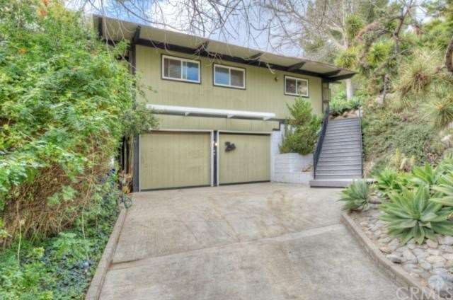 Driveway to garage and steps to main level