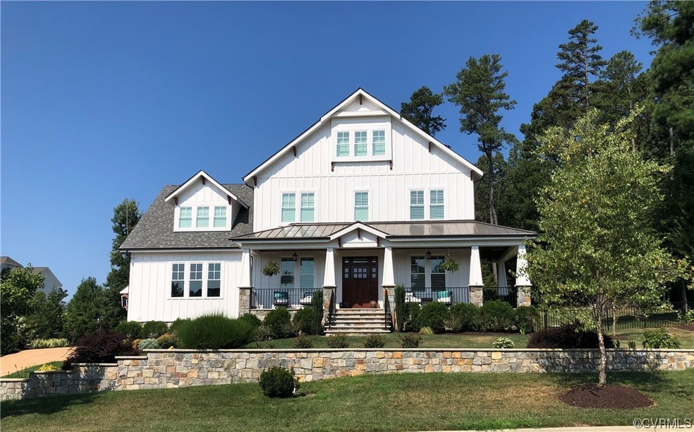 View of front of home with a porch and a front yar