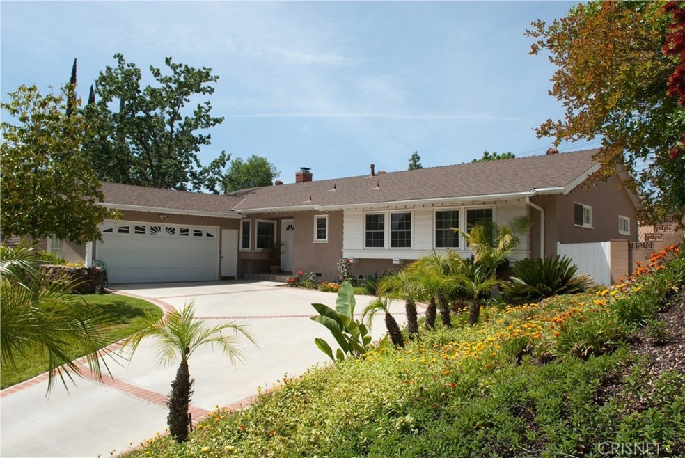 Amazing curb appeal highlighted by lush landscaping