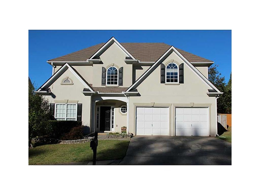 Exterior Front. Hard-coat Stucco. Flat yard and dr