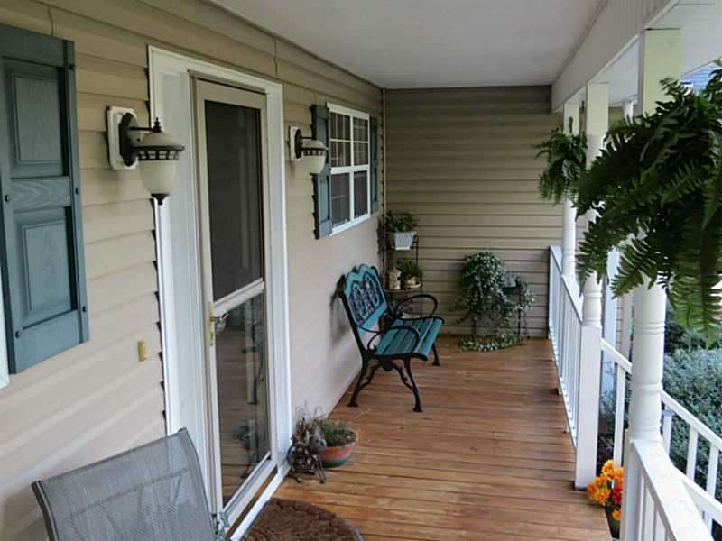 Exterior Front. Cozy porch,earthy colors and charm