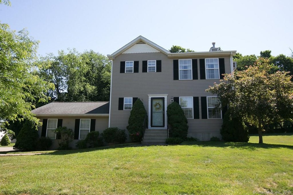 Front of house. Beautifully manicured lawn.