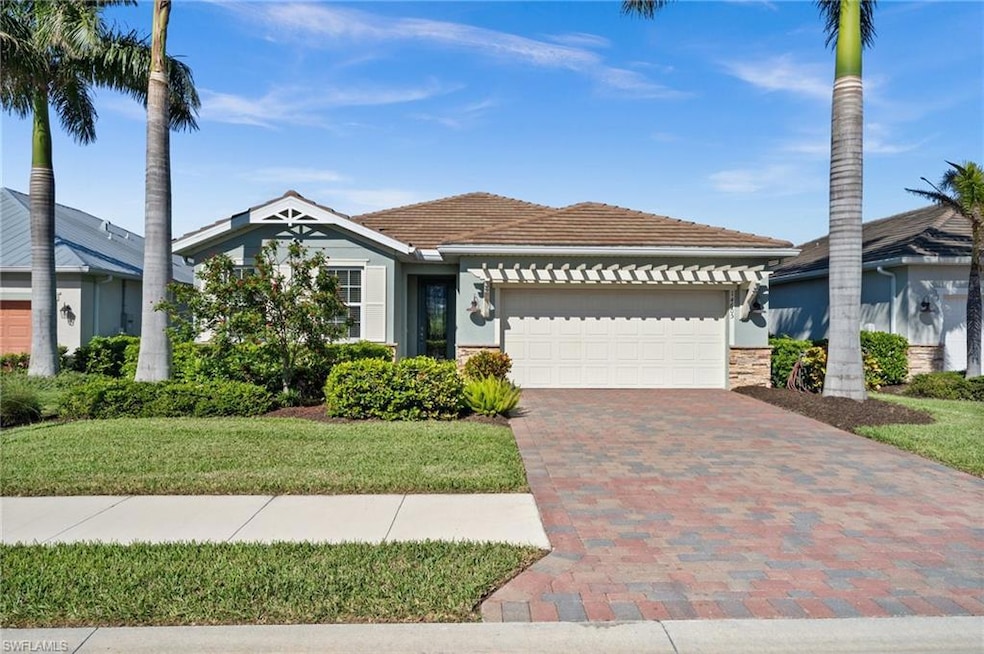 View of front of house with a garage and a front y