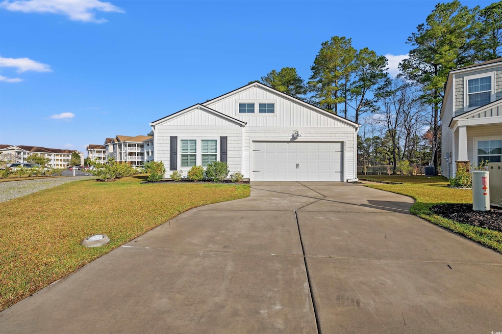 View of front of home with a front lawn, board and