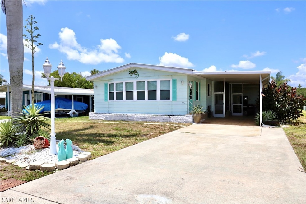 View of front of home with a front yard and a carp