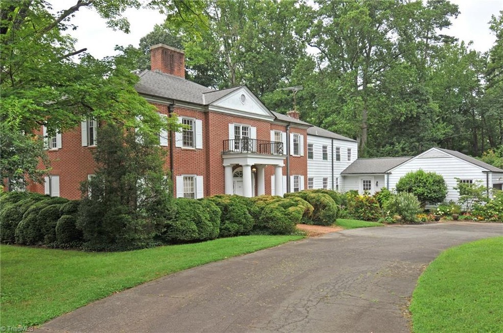 Traditional brick manor with mature landscaping and circle driveway