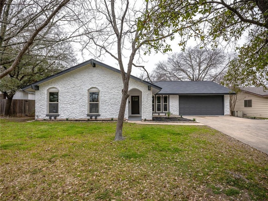 Ranch-style house featuring a front yard, an atta