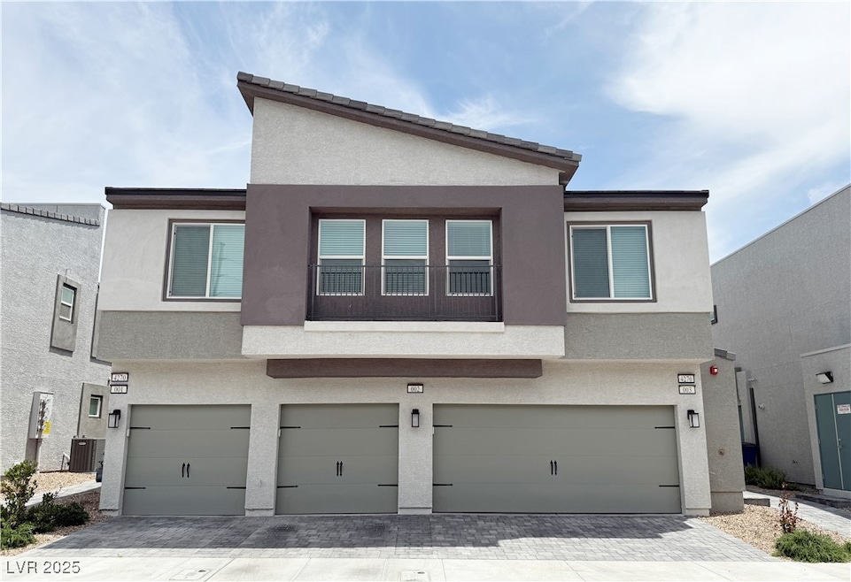 Townhome / multi-family property featuring an atta