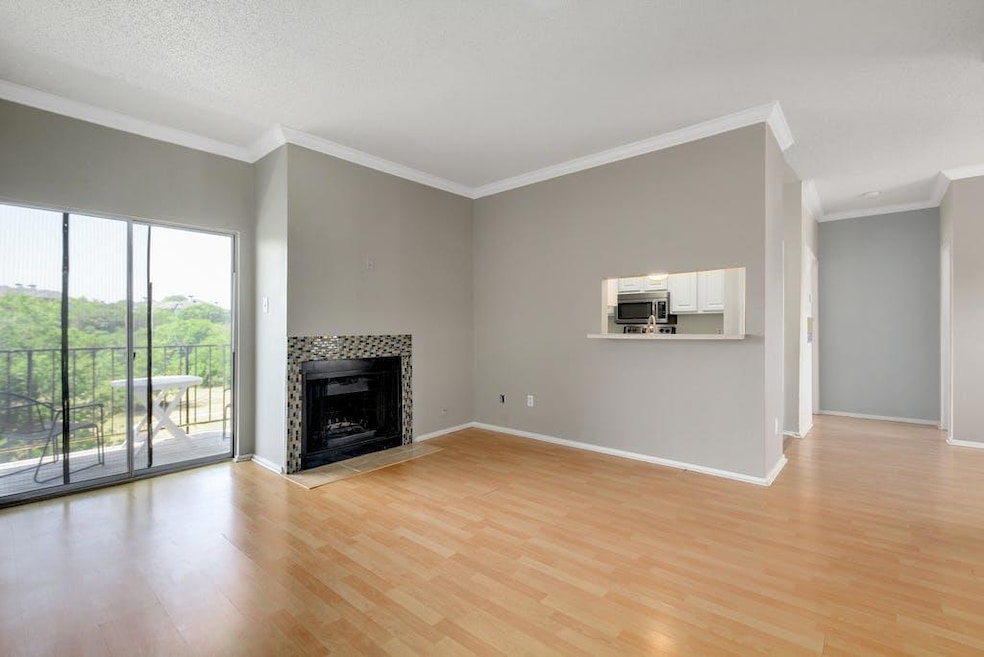 Unfurnished living room featuring baseboards, lig