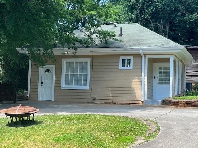 View of front of home with a front yard, a patio, 