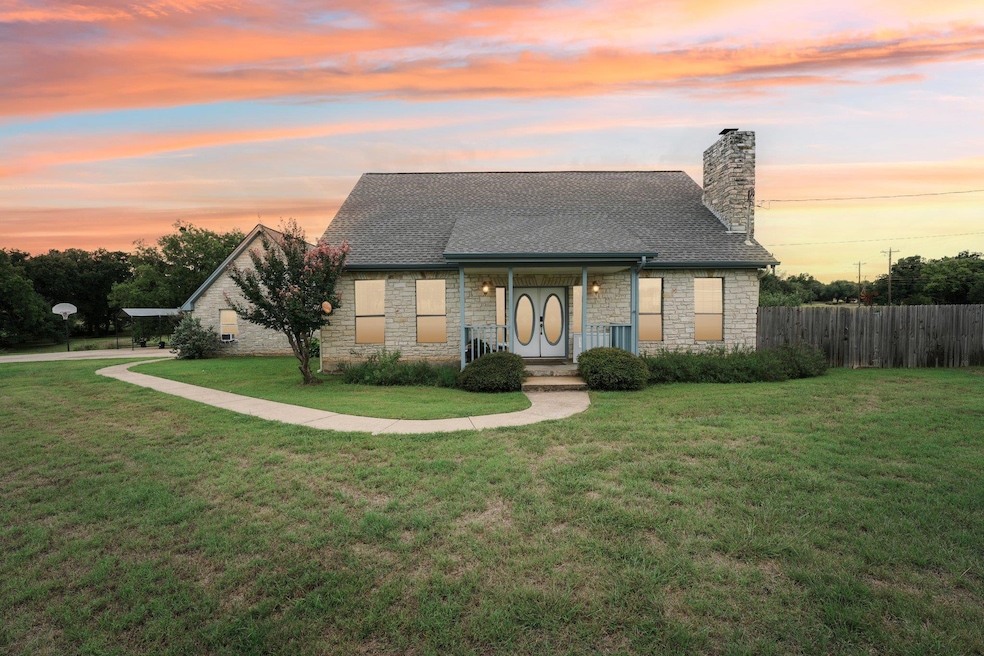 View of front of house featuring stone siding, a 