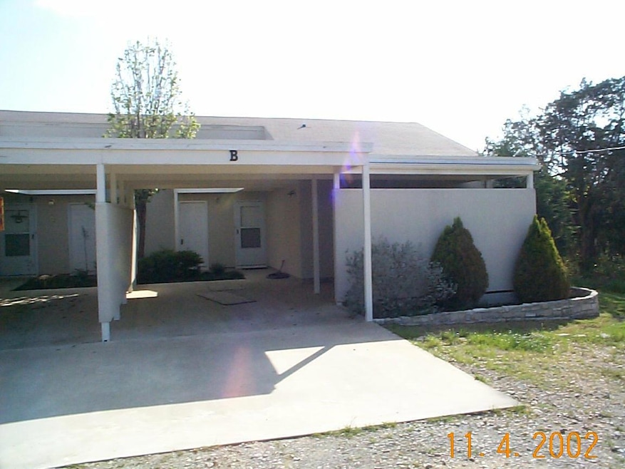 Rear view of property with a carport, stucco sidi