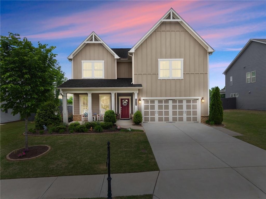 View of front of home featuring a porch, board and
