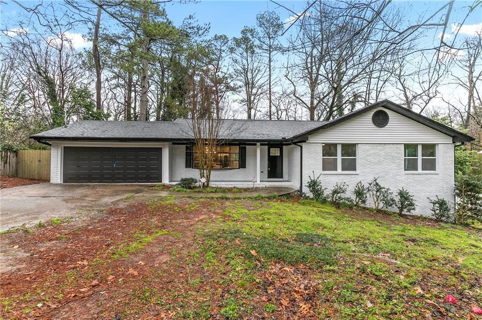 Ranch-style house with driveway, fence, a front ya