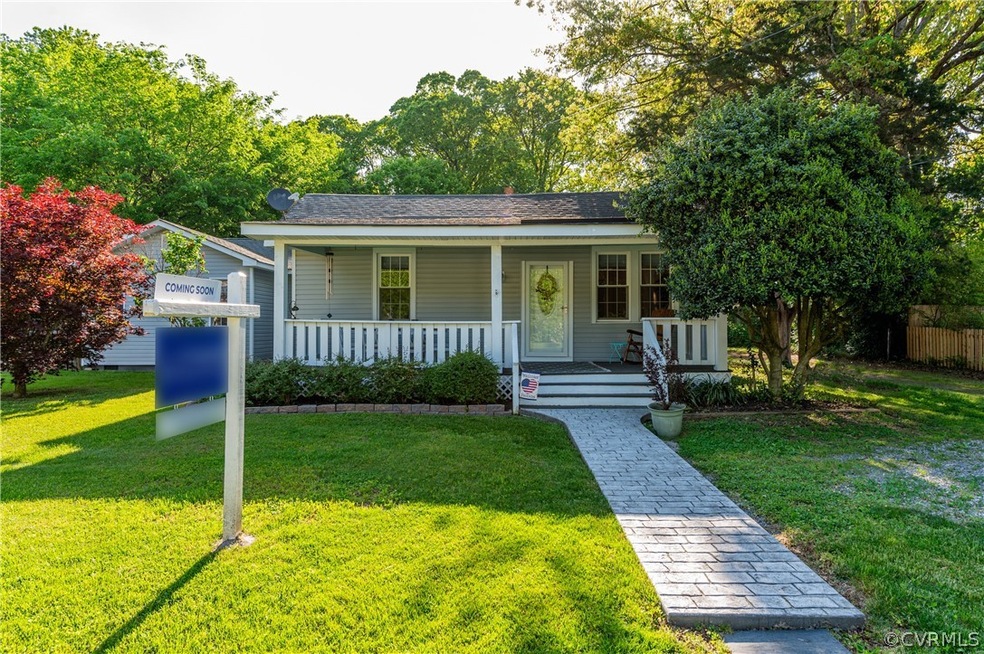 View of front of property with a front lawn and covered porch