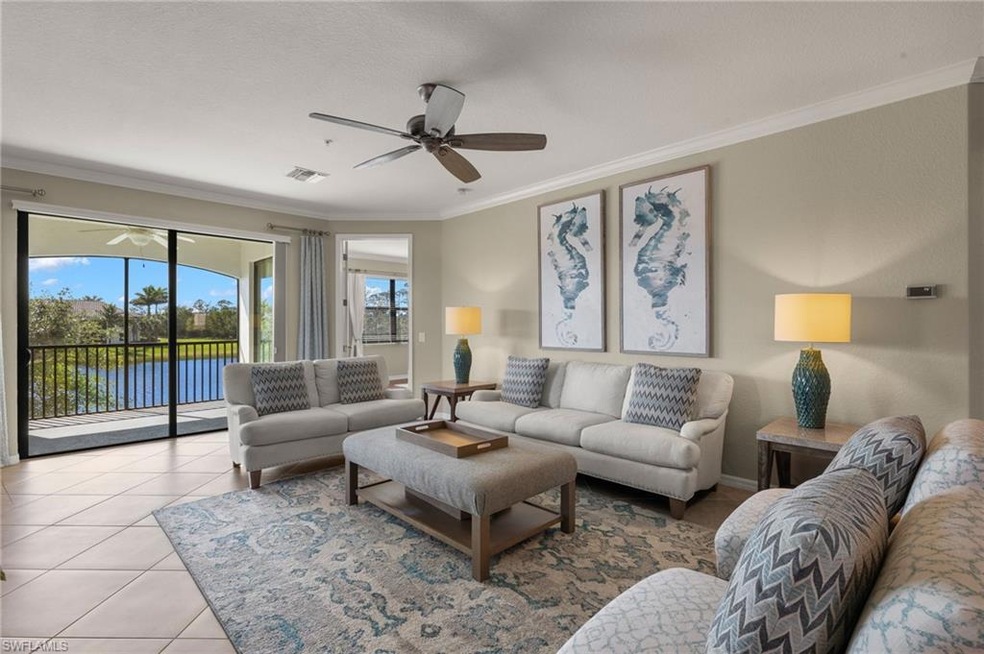 Tiled living room featuring crown molding, ceiling