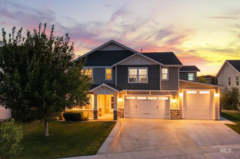 Craftsman-style house featuring stone siding, a yard, driveway, an attached garage, and a porch