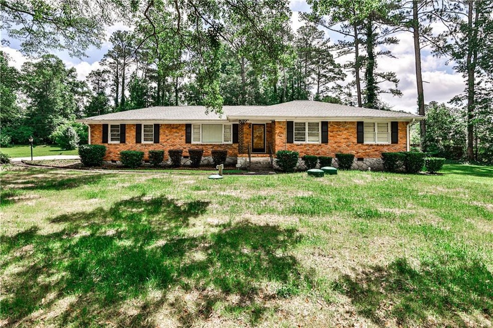 Ranch-style house featuring a front lawn