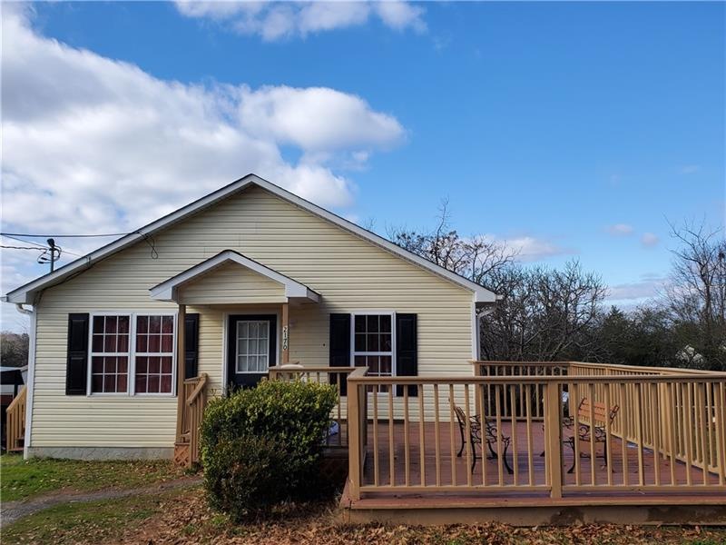 House front, vinyl siding shows well. Front deck i