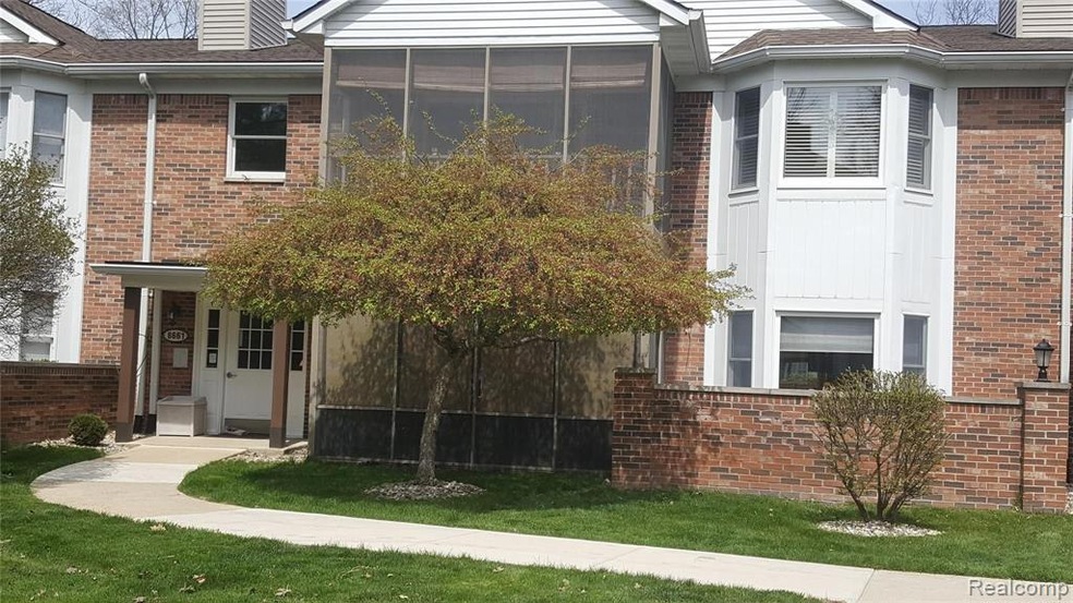 Front view of screened porch & brick wall patio.