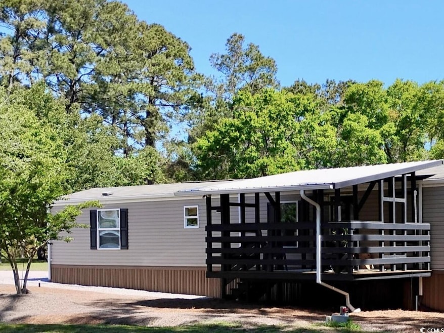 View of front of house featuring a wooden deck