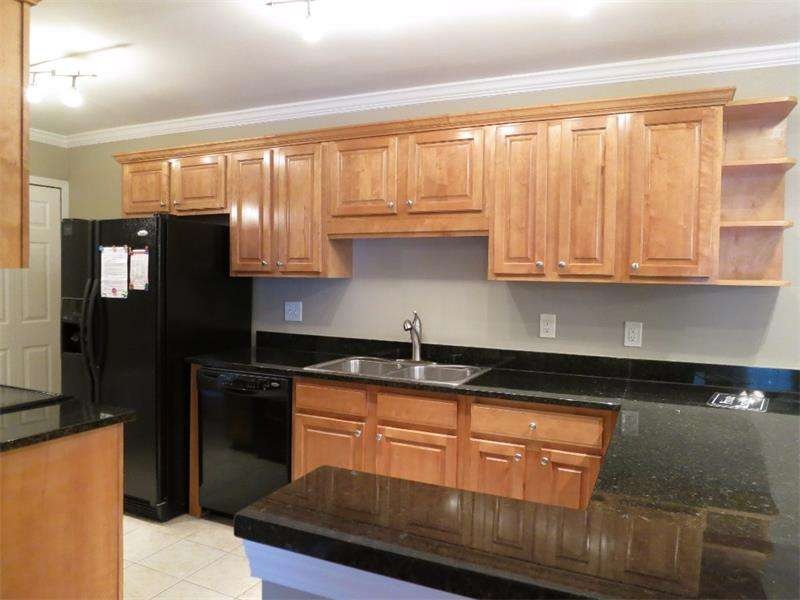 Beautiful granite counter top with stained cabinet