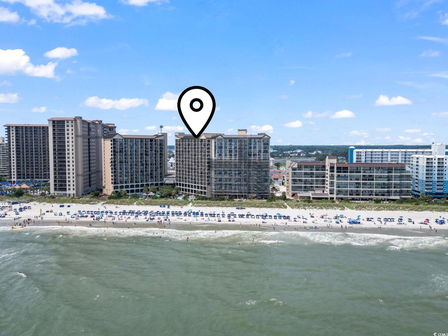 Aerial view featuring a beach view and a water vie