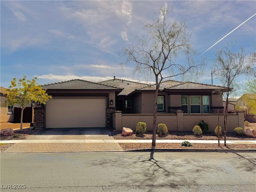 View of front of home with driveway, a fenced fron