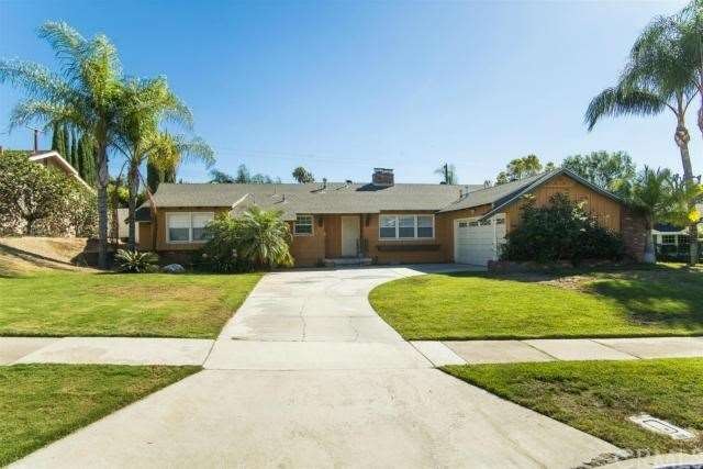 A long driveway and spacious front yard greet you 