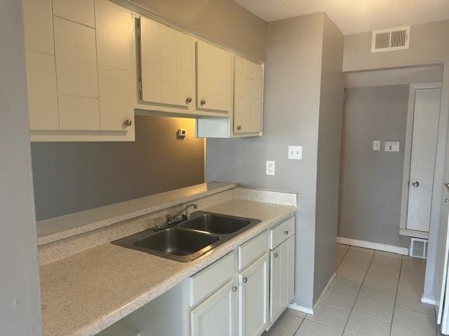 Kitchen featuring sink, light tile patterned floor